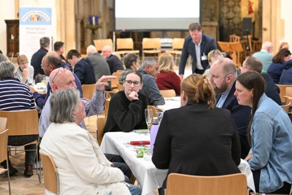 Residents in a hall having discussions