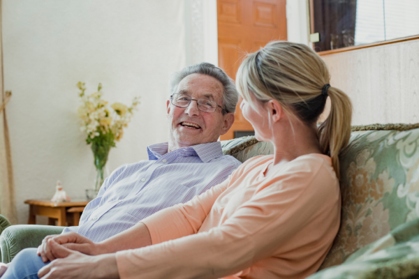 Older person sitting with a carer