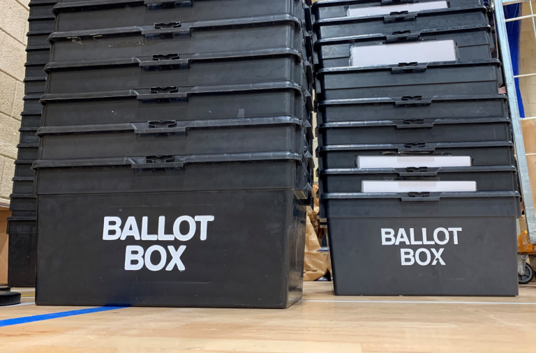 A stack of ballot boxes on the floor