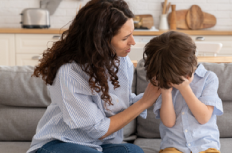A woman comforts an unhappy child while sat on the sofa