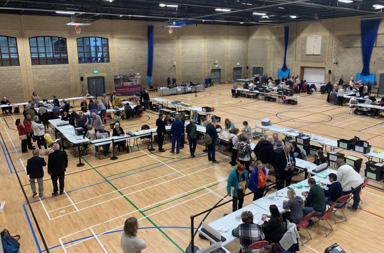 Colleagues count ballots at the local election count at Loddon Valley Leisure Centre