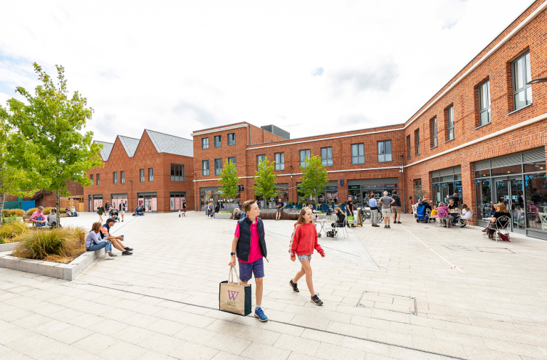 Two children walking through Peach Place in Wokingham