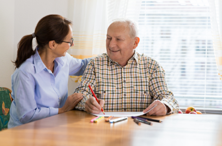 Older man sitting with care worker