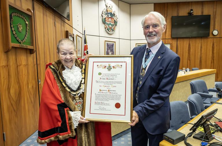 Wokingham Borough Mayor Cllr Beth Rowland with Mr Angus Ross holding the framed scroll