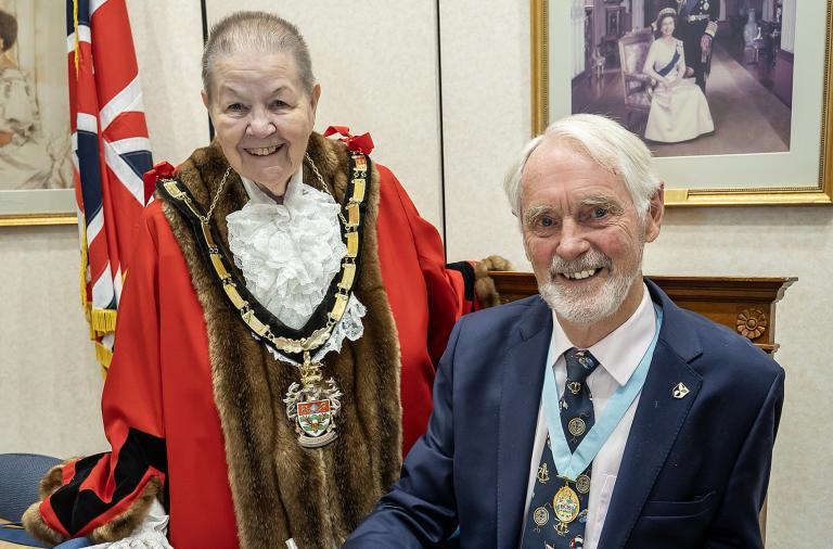 Wokingham Borough Mayor Cllr Beth Rowland with Mr Angus Ross who is signing a book