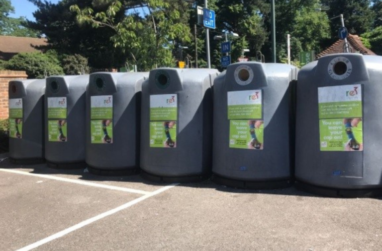 Row of 6 bottle banks in a car park with re3 signage