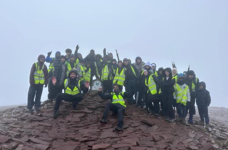 Members of Bracknell Islamic Cultural Society celebrate reaching the top after climbing a mountain