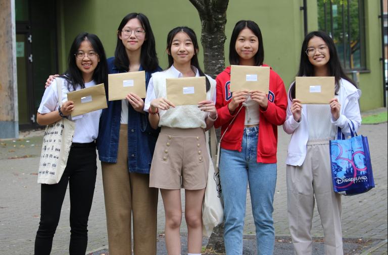 Five GCSE students posting with their results