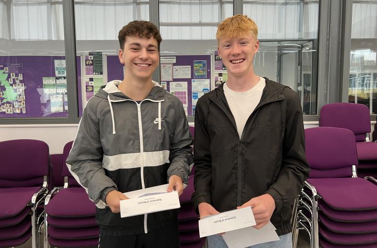 Two GCSE students posting with their results