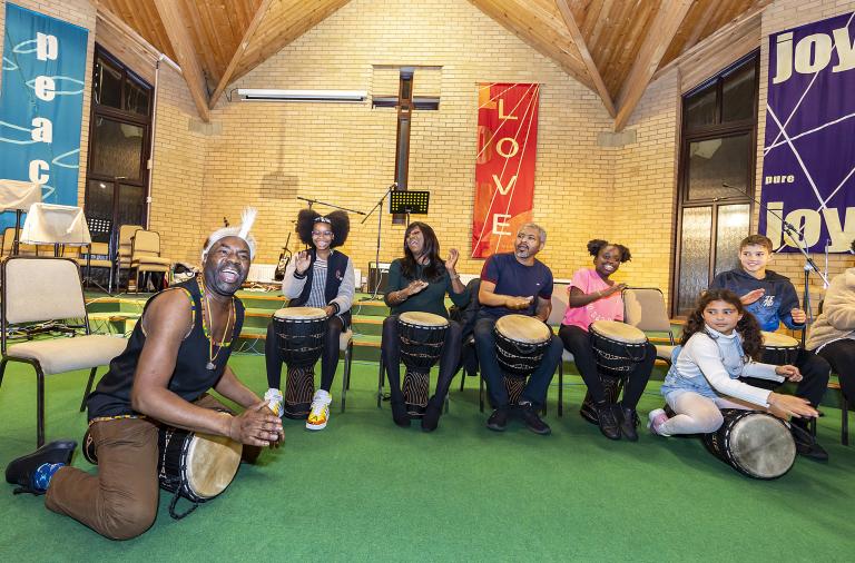 Drummers and children create a performance during the Black History Month event