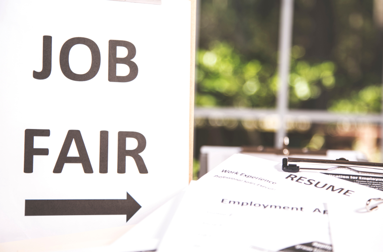 A sign reading job fair and an arrow