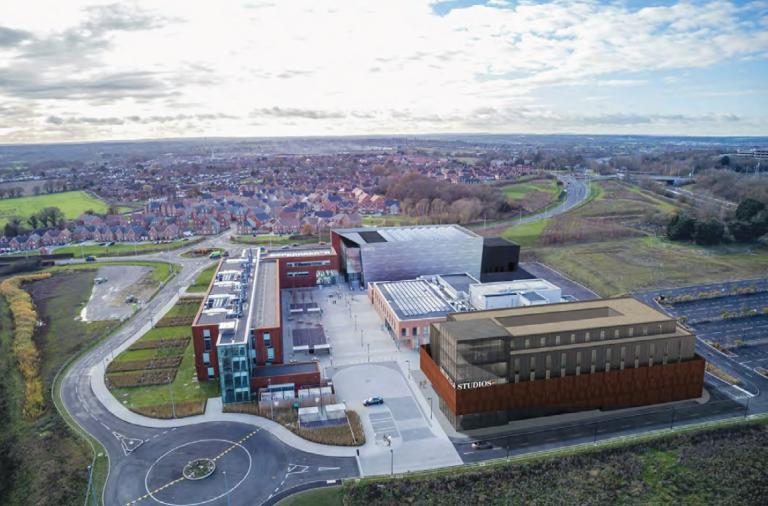 Artist's impression showing a modern studio complex from above with Shinfield village in the background