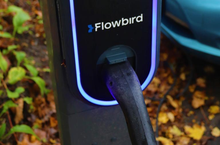 Close up of the chargepoint with glowing blue border and the Flowbird logo