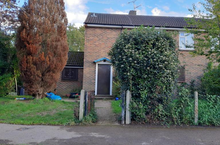 A house with the front door boarded up