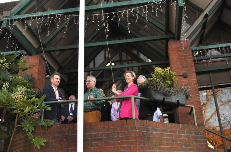 Councillors raising the white ribbon flag above Shute End