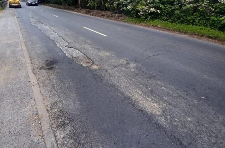 Image of road surface delamination on a main road