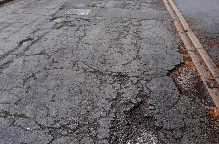 Image of surface course deterioration on a residential road