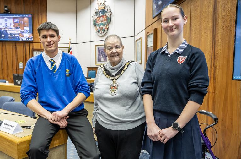 Borough mayor Beth Rowland stands in the council chambers between newly elected youth mp and vice youth mp