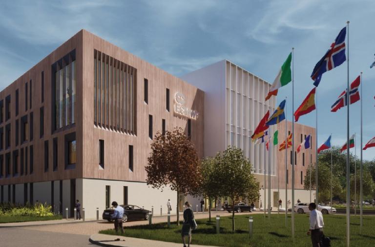 Computer generated image from ground level of a modern four storey block surrounded by flags from around the world