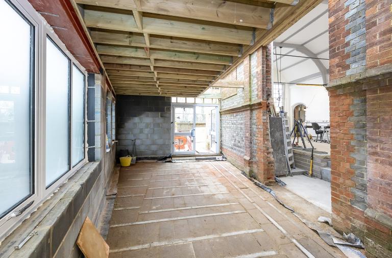 New Twyford Library extension with exposed Victorian brickwork linking through to the main hall