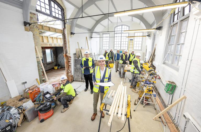 Cllr Stephen Conway and contractors in the main hall of the new Twyford Library