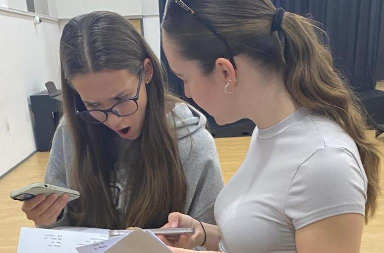 Two students look in shock at their results