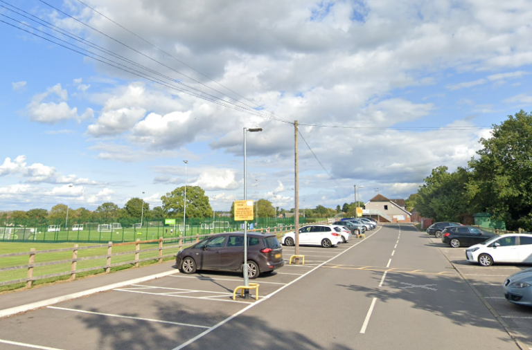 Cars parked in the car park alongside the green space at Cantley Park in Wokingham