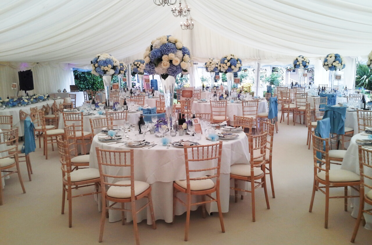 Photo of an indoor wedding, chairs in a marquee 