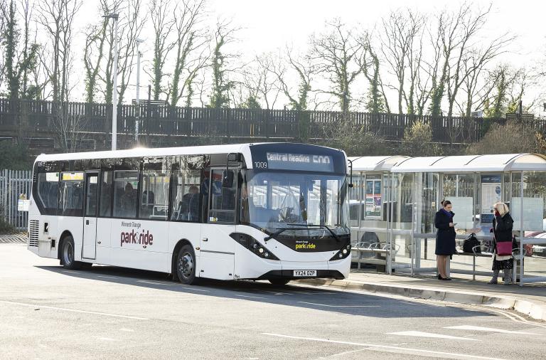 A bus pulls up to collect people at Winnersh Triangle park and ride