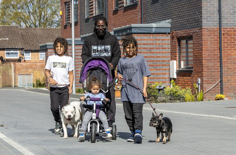 Family walking through part of the new Gorse Ride housing area