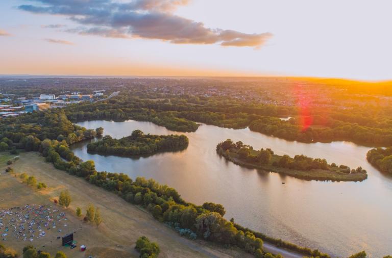 Drone shot of Dinton Pastures Country Park overlooking the lake and field