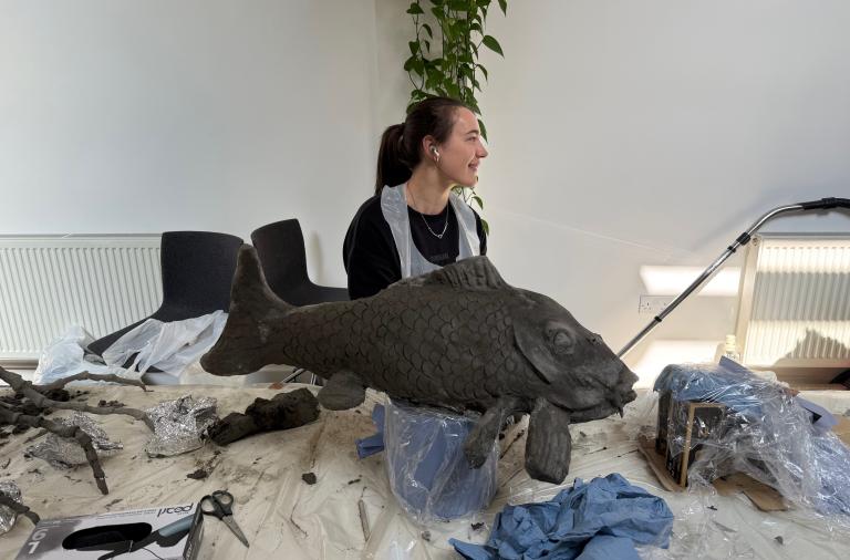 Artist creating a fish as part of the artwork going on display for Forest of Imagination