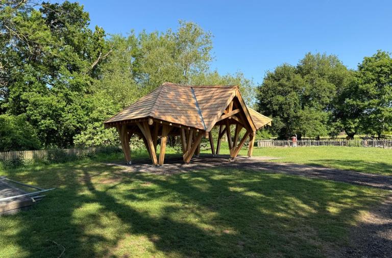 An open sided wooden shelter newly installed at Dinton Pastures