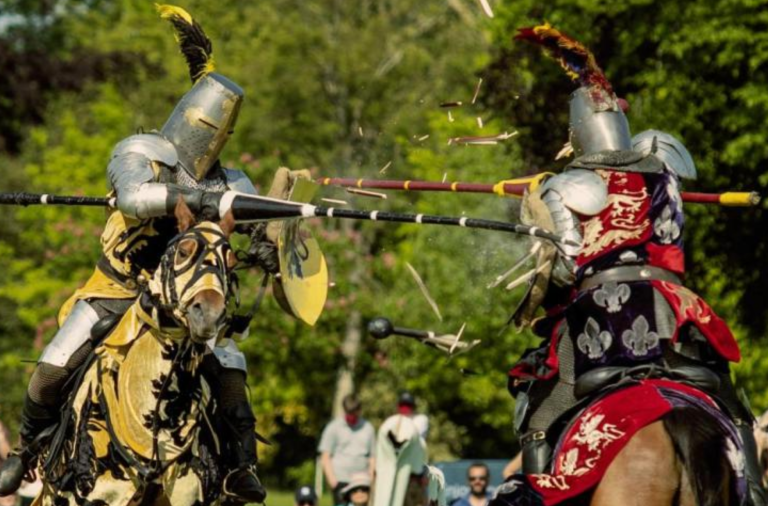 Two people on horses at medieval jousting event