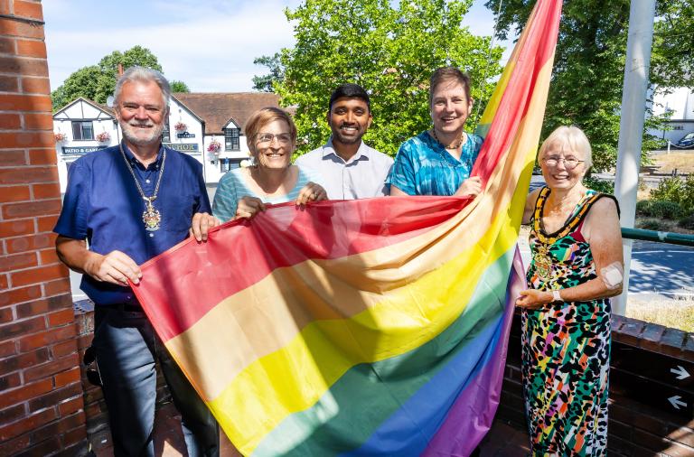 Wokingham Borough councillors raise the Pride rainbow flag at the council's Shute End offices