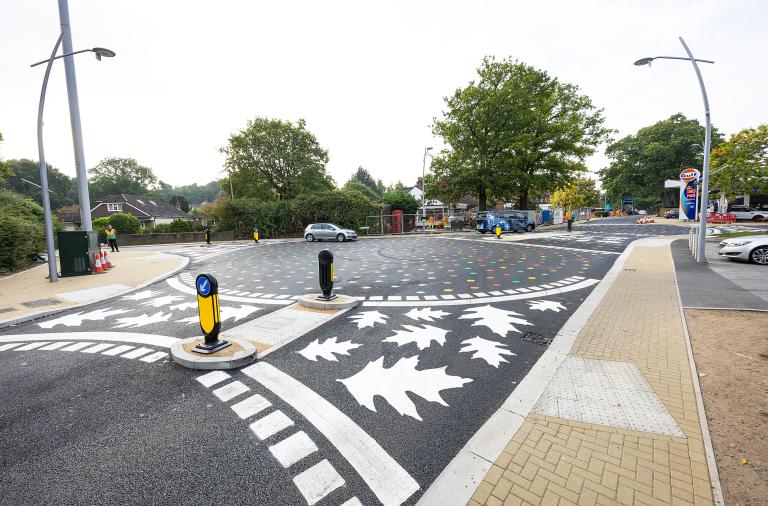 Close up of a pedestrian crossing point at California Crossroads with large white leaves painted on the route across