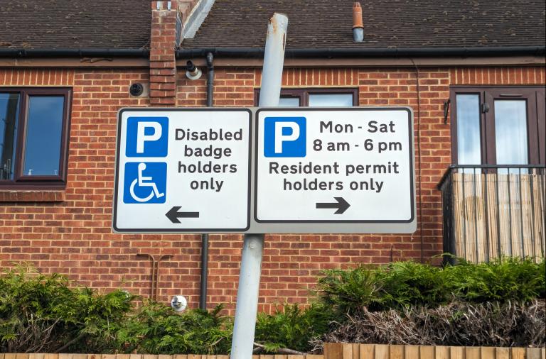 Parking permit restrictions on a sign