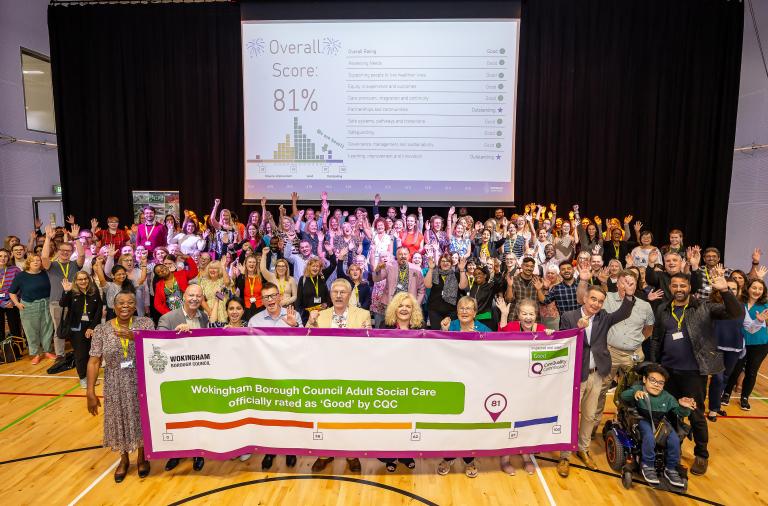 Colleagues with CQC result banner cheering