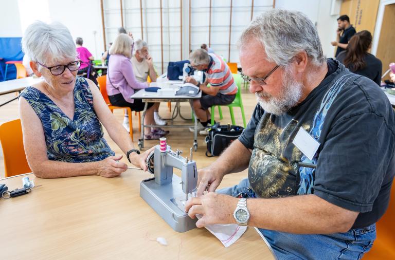 Fixing things at the repair cafe with a sewing machine