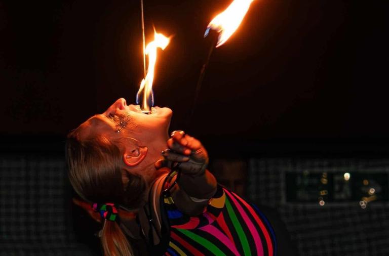 A lady breathing fire