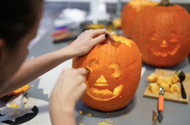 A child carving a pumpkin
