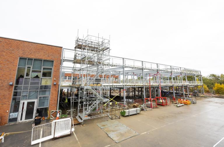 An image showing the new sixth form's building frame next to the existing Bohunt school building