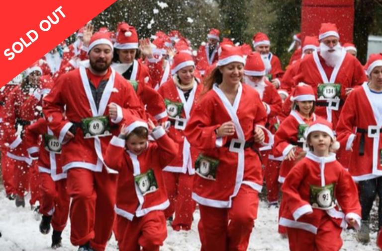 Group of people dressed as Santa running
