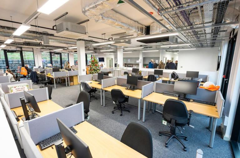 Open-plan office space with desks, computers, and exposed ceiling at Toutley Depot.