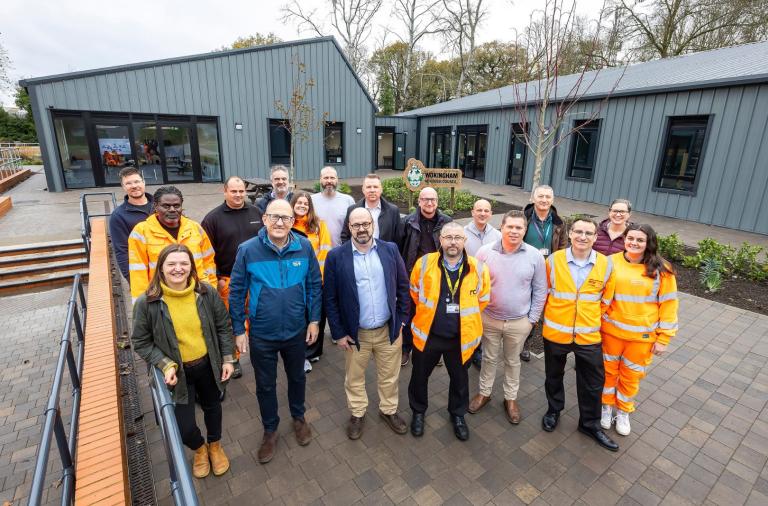 Group of people standing in courtyard outside new Toutley Depot offices.