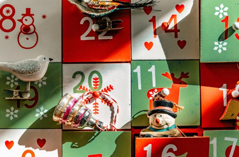 Close-up of an advent calendar with festive decorations.