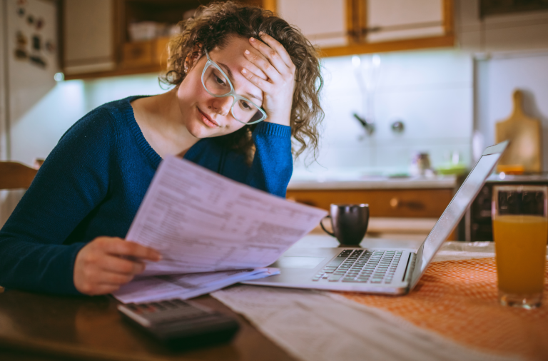 Woman looking at bills