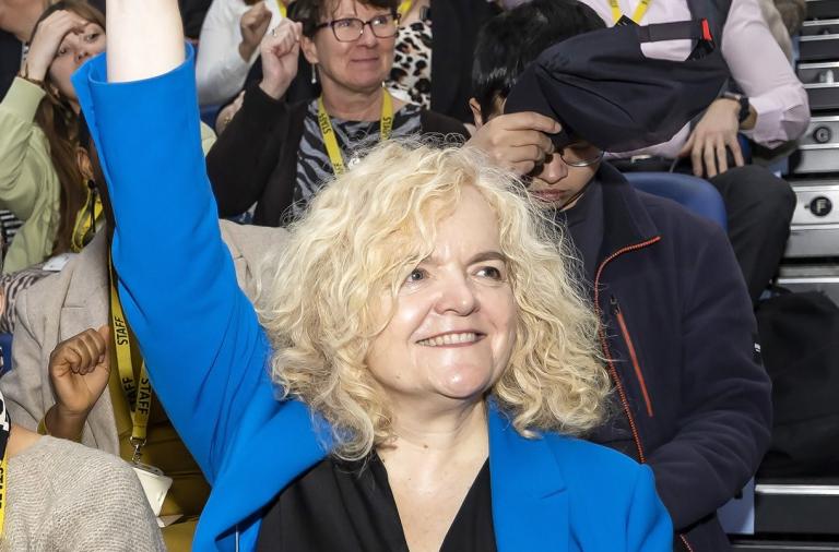 Chief Executive raising hand and smiling