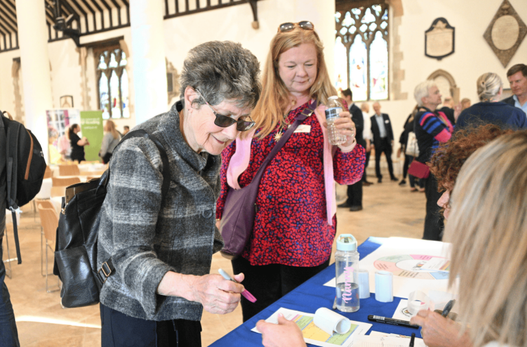 Person signing a piece of paper