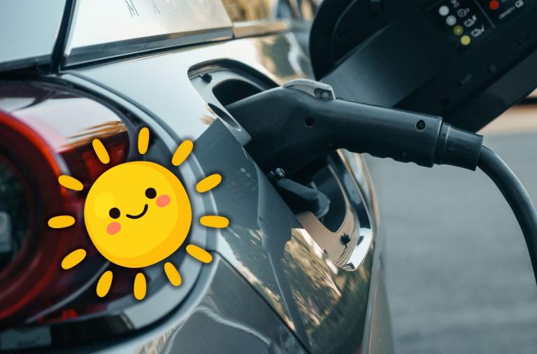Photo of a charger plugged into an electric vehicle with a graphic of a smiling sun